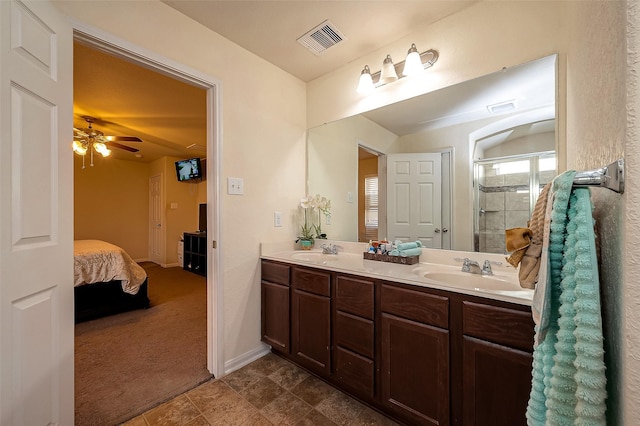 bathroom with tile patterned flooring, ceiling fan, a shower with shower door, and vanity