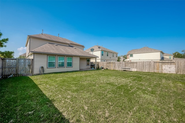 back of house with a yard