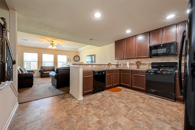 kitchen featuring kitchen peninsula, backsplash, a textured ceiling, ceiling fan, and black appliances