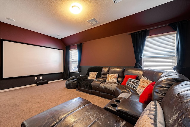 home theater featuring a textured ceiling, carpet floors, and lofted ceiling