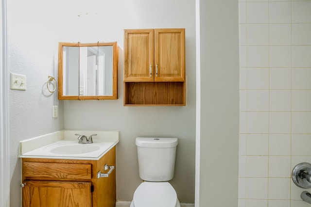 bathroom with vanity, toilet, and walk in shower