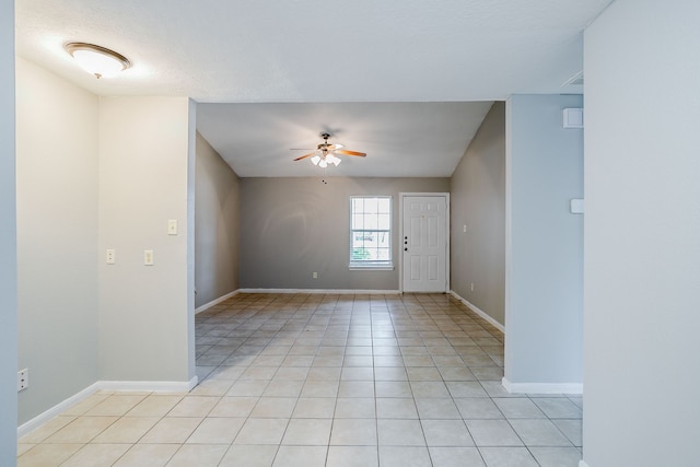 tiled empty room with ceiling fan