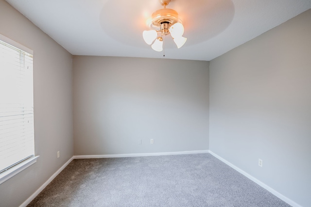 carpeted empty room featuring ceiling fan