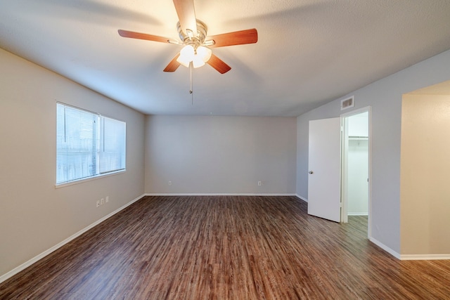 spare room featuring ceiling fan and dark hardwood / wood-style flooring