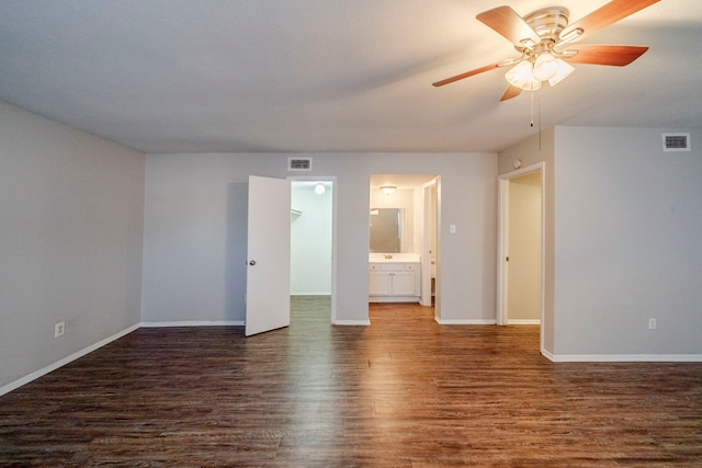 spare room with ceiling fan and dark wood-type flooring