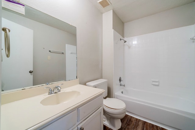 full bathroom featuring vanity, wood-type flooring, shower / bathtub combination, and toilet