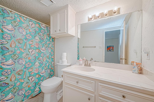 bathroom with tile patterned flooring, vanity, toilet, and a textured ceiling