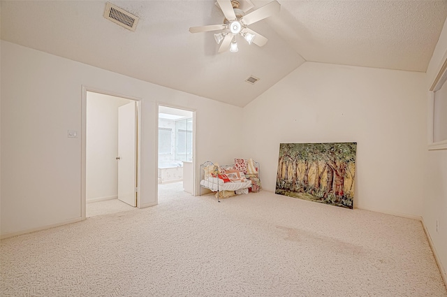 sitting room featuring carpet, a textured ceiling, vaulted ceiling, and ceiling fan