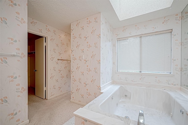 bathroom featuring a bathing tub and a textured ceiling