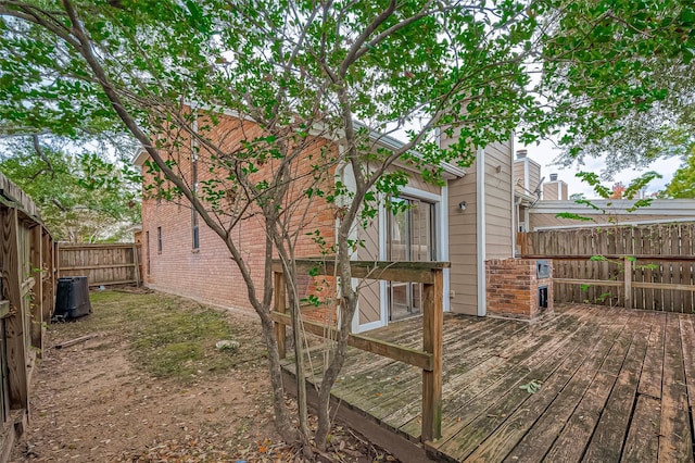 exterior space featuring a wooden deck and central AC