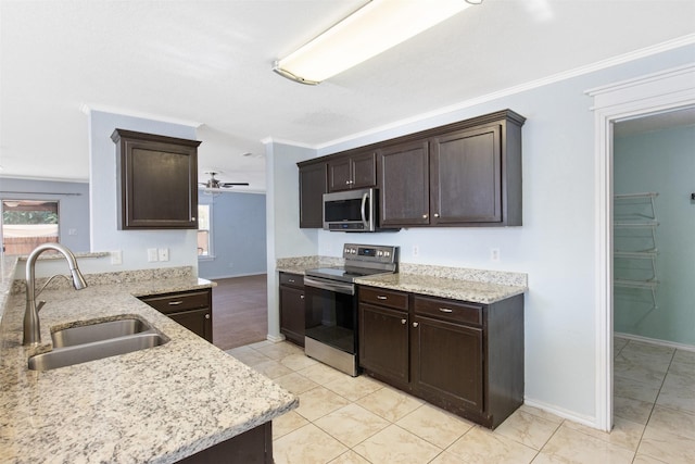 kitchen featuring appliances with stainless steel finishes, dark brown cabinets, ornamental molding, and sink