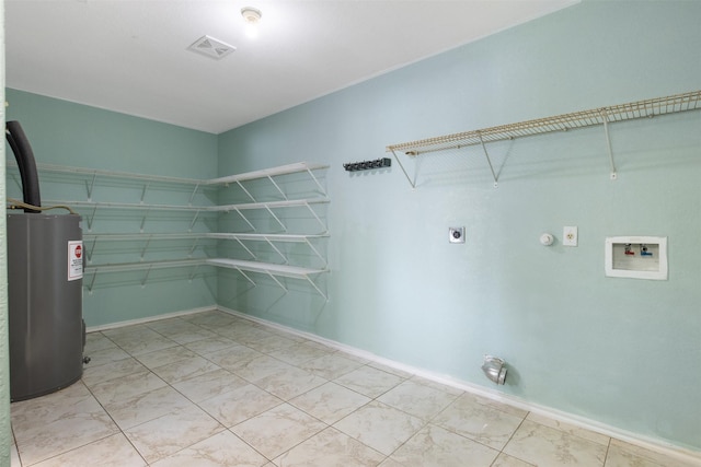 clothes washing area featuring hookup for an electric dryer, washer hookup, and electric water heater