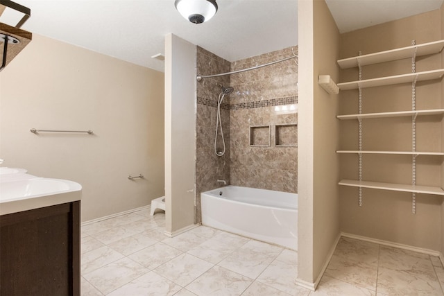 bathroom with vanity and tiled shower / bath