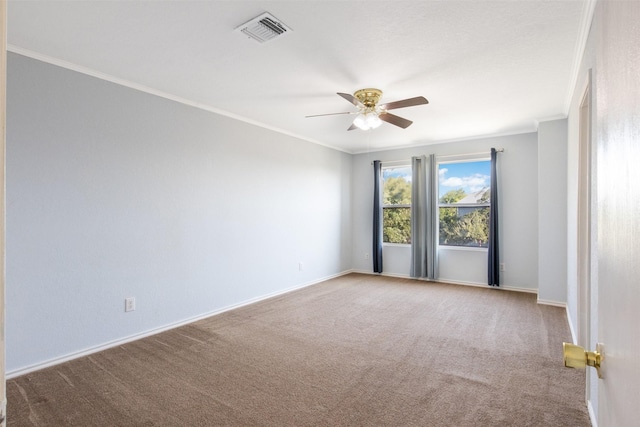 empty room featuring ceiling fan, carpet floors, and ornamental molding