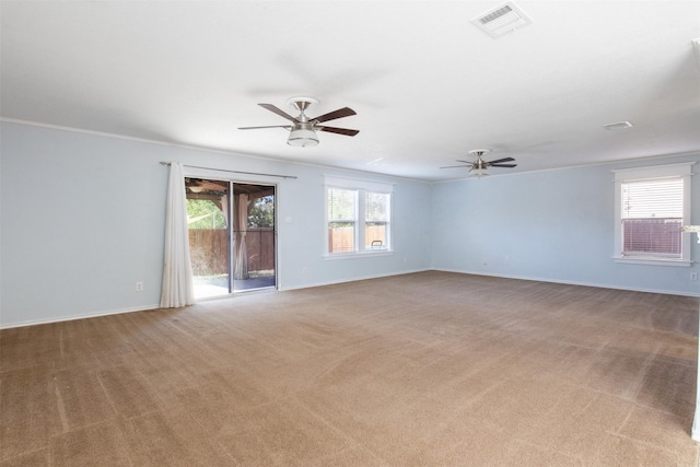 carpeted empty room with ceiling fan and crown molding