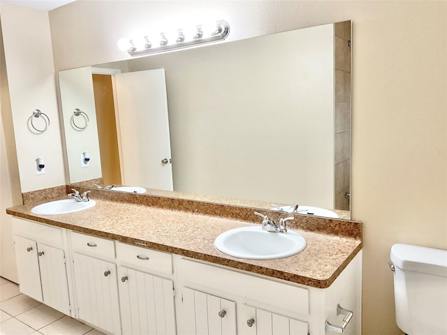 bathroom featuring tile patterned floors, vanity, and toilet