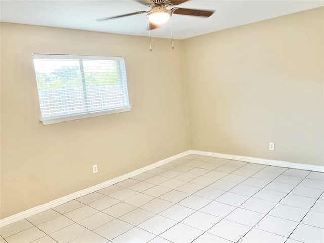 tiled empty room featuring ceiling fan