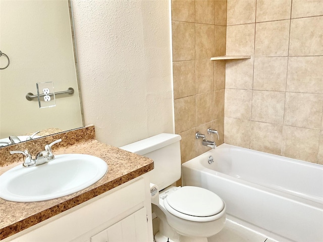 full bathroom with vanity, tiled shower / bath combo, and toilet