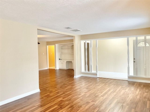 interior space with hardwood / wood-style flooring and a textured ceiling