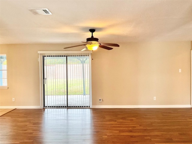 empty room with hardwood / wood-style floors and ceiling fan