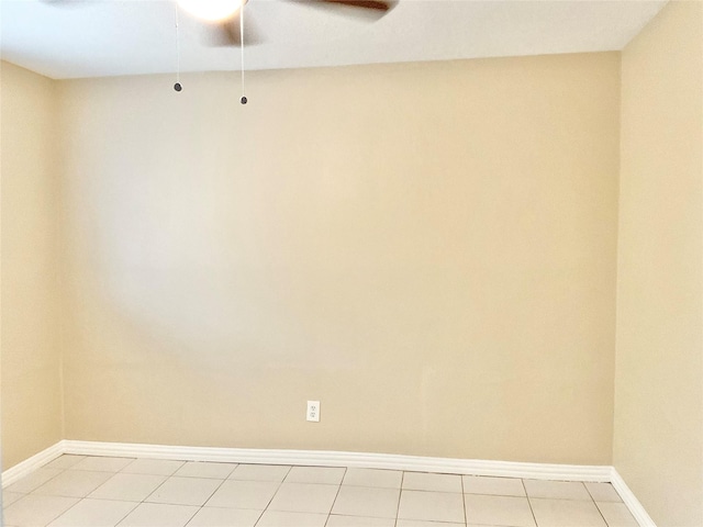 tiled empty room featuring ceiling fan