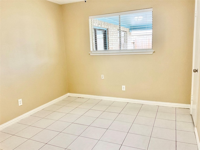 spare room featuring light tile patterned floors