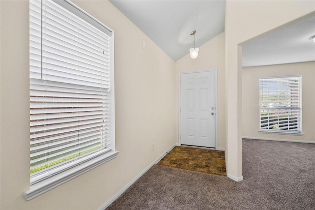 carpeted foyer entrance with vaulted ceiling