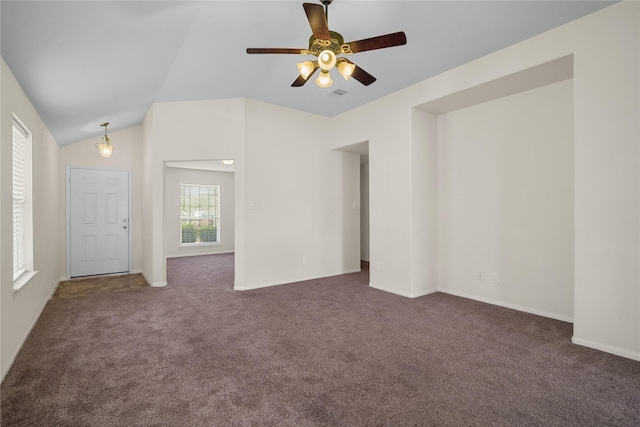 carpeted spare room featuring ceiling fan and vaulted ceiling