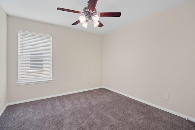 spare room featuring a wealth of natural light, carpet, and ceiling fan