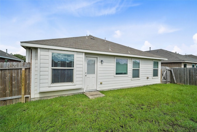 back of property featuring a lawn