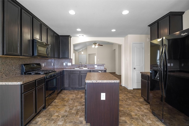 kitchen with backsplash, ceiling fan, sink, black appliances, and a center island