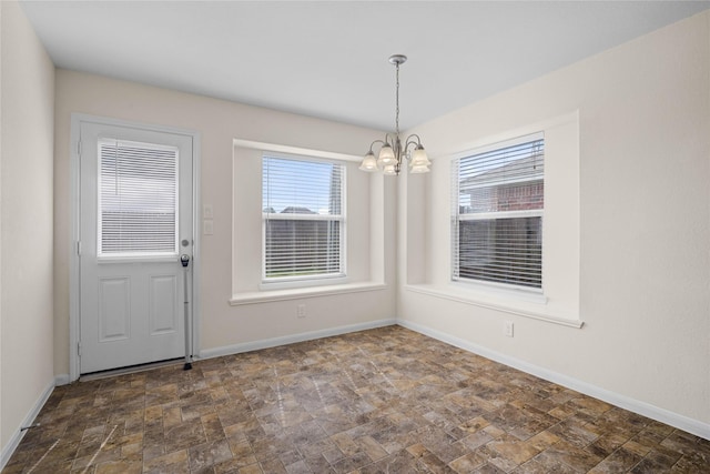 unfurnished dining area with a chandelier