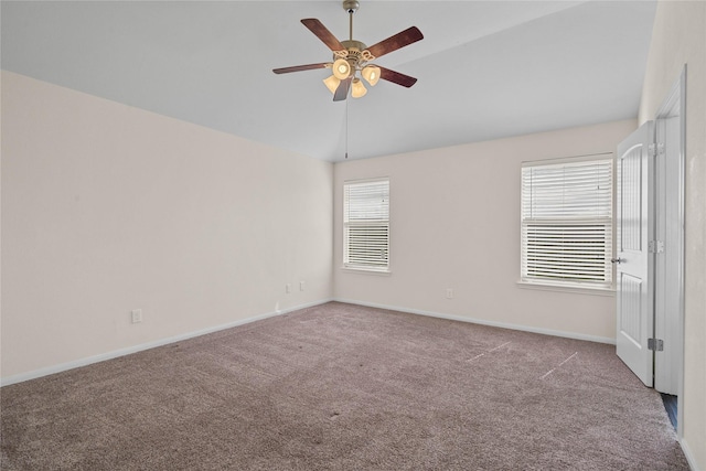 carpeted spare room featuring ceiling fan, a wealth of natural light, and vaulted ceiling