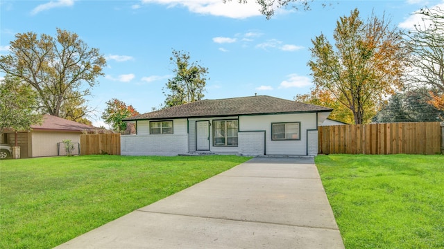 ranch-style home with a front lawn