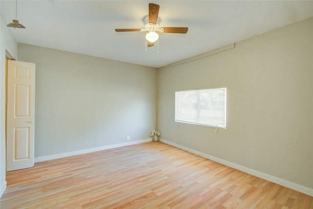 spare room with ceiling fan and light wood-type flooring