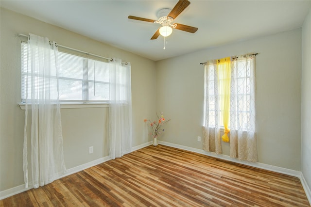 spare room with ceiling fan and wood-type flooring