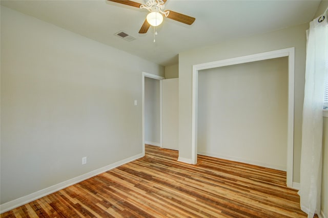 unfurnished bedroom featuring ceiling fan, a closet, and light hardwood / wood-style flooring