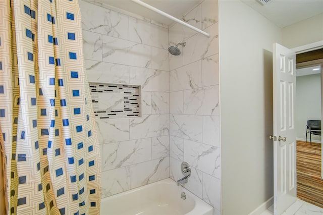 bathroom with shower / bathtub combination with curtain