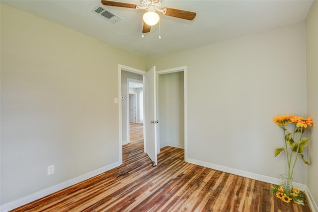 empty room with ceiling fan and hardwood / wood-style floors