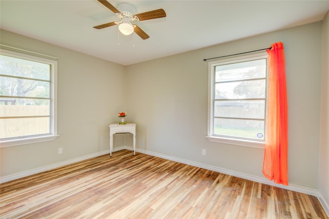 empty room with light wood-type flooring, plenty of natural light, and ceiling fan