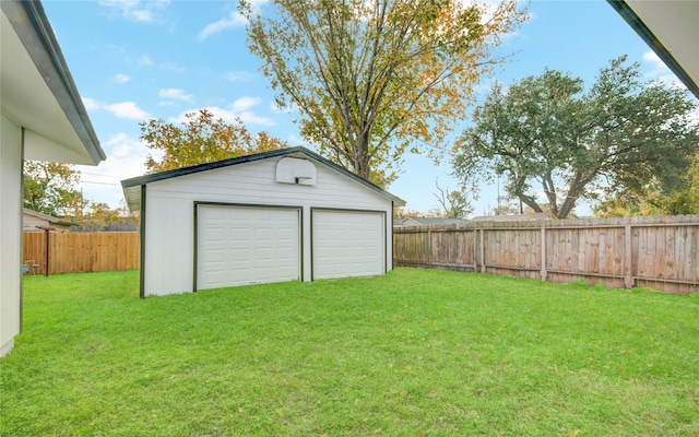 garage featuring a lawn