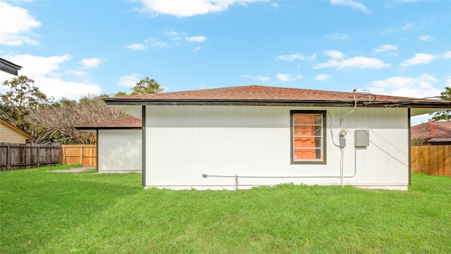 back of house with a lawn