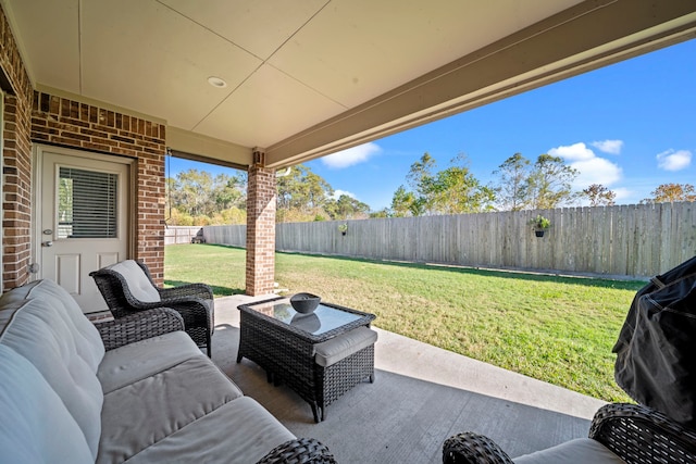 view of patio / terrace with area for grilling, a fenced backyard, and an outdoor living space