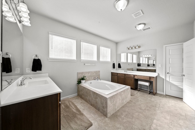 bathroom with two vanities, visible vents, a sink, and a bath