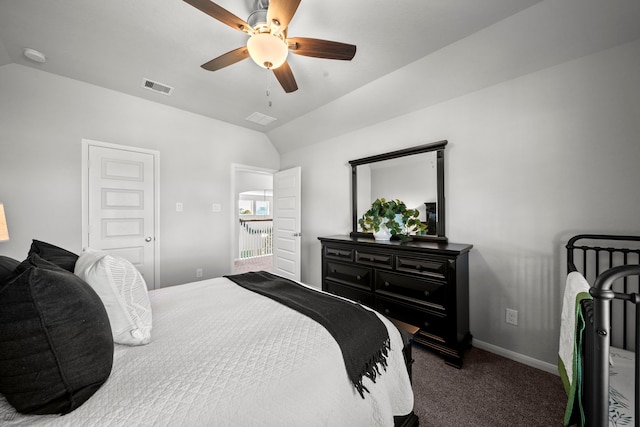 bedroom featuring lofted ceiling, visible vents, dark carpet, a ceiling fan, and baseboards