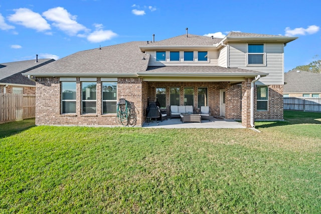 rear view of house with a yard, a fenced backyard, a patio, and an outdoor hangout area