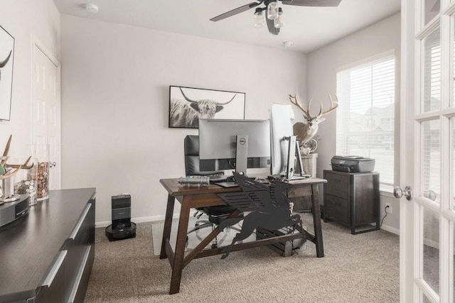 carpeted home office featuring french doors, ceiling fan, and baseboards