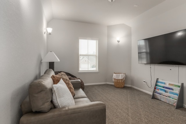 carpeted living room featuring lofted ceiling and baseboards