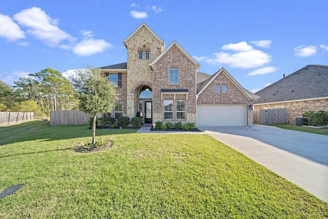 traditional-style house featuring brick siding, a front yard, fence, a garage, and stone siding