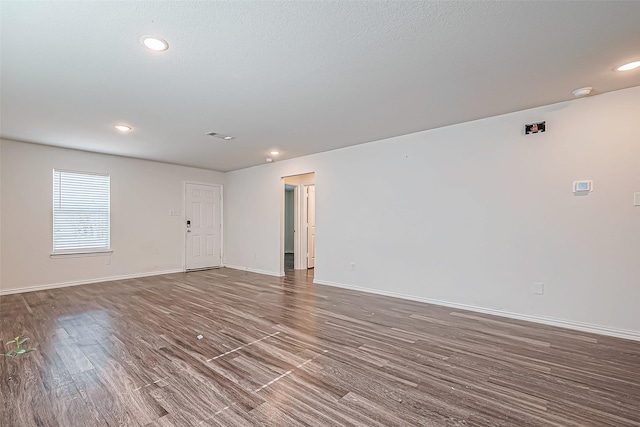 spare room with dark hardwood / wood-style floors